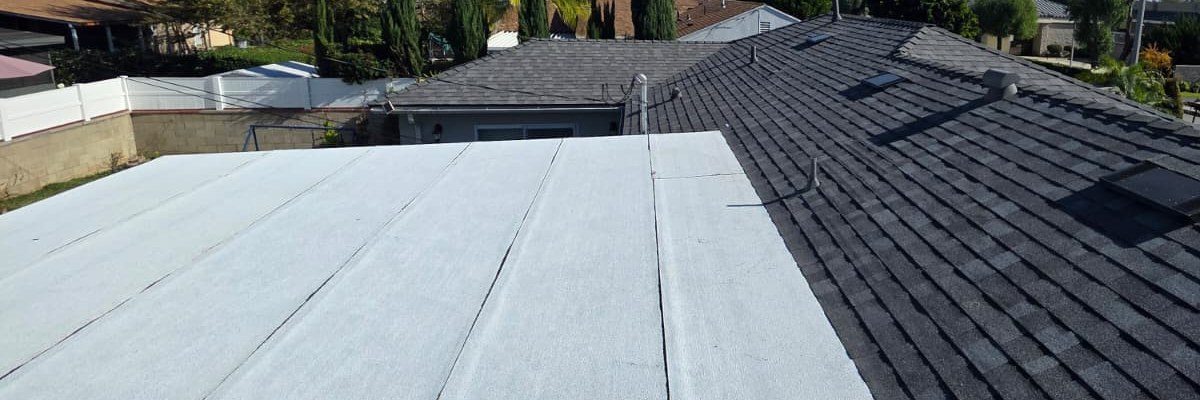 White low-slope roof section next to a dark shingle roof section